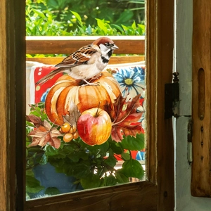 Close-up of autumn window decals showing realistic sparrows, pumpkins and maple leaves