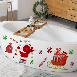 Detail of Christmas Santa and sleigh wall decals applied on a bathtub for festive decor