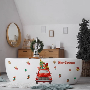 Close-up of festive Merry Christmas stickers featuring red truck and tree on bathtub