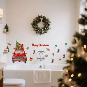 Close-up of Merry Christmas wall stickers with red truck and festive elements on white tile