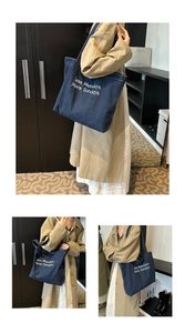 Detail of blue denim tote bag featuring the white slogan Less Mondays More Sundays print