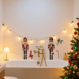 Detail of Christmas wall stickers featuring nutcrackers and candles on a tiled bathroom wall