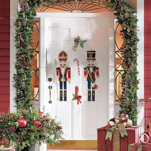 Detail of Christmas nutcracker soldier wall stickers and festive candle decals on a white door