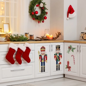 Detail of Christmas Nutcracker stickers and festive elements on white kitchen cabinets