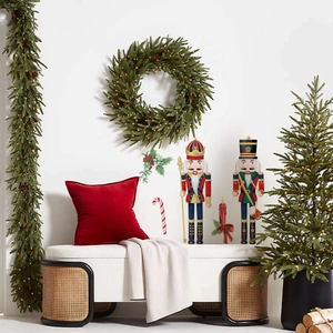 Detail of Christmas wall stickers featuring nutcrackers and festive candles on a white wall