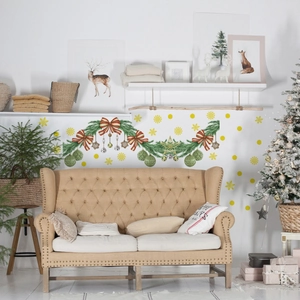 Close-up of Christmas wall stickers featuring green garlands, red bows and golden stars