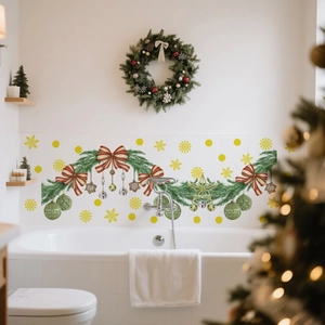 Christmas wall decal detail featuring green pine branches, red bows and festive ornaments