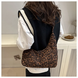 Leopard print hobo shoulder bag shown on model for size and drape perspective