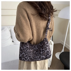 Detail of purple leopard print hobo bag with knotted shoulder strap texture