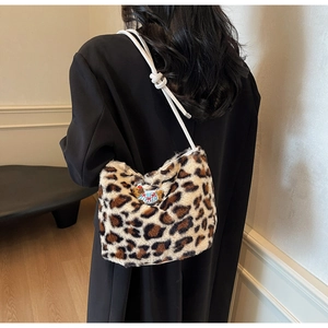 Detail of plush leopard print shoulder bag with a cute bear embroidery and rope strap