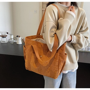 Caramel corduroy tote bag showing side pocket detail and textured fabric in casual setting