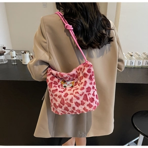 Pink leopard print plush bag with cute bear embroidery shown on a female model shoulder