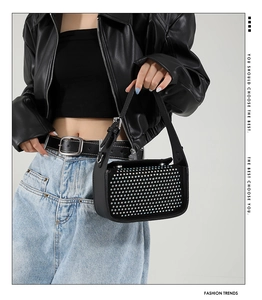 Detail of black crossbody bag with silver rhinestones and adjustable strap buckles