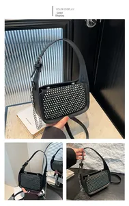 Detail of black crossbody bag with sparkling rhinestones and thick silver chain strap