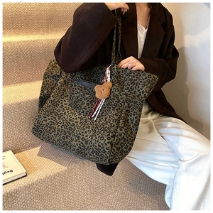Large capacity leopard print tote bag with plush bear charm and ribbon on model