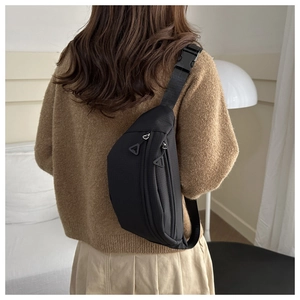 Detailed view of black waffle texture sports chest bag with adjustable strap on a model