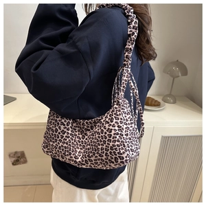 Detail of leopard print shoulder bag featuring a unique gathered pleated strap design