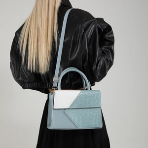 Women's blue and white patchwork crossbody bag with crocodile texture and top handle