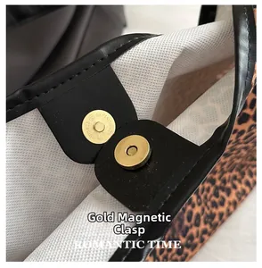 Close-up of leopard print bag featuring gold magnetic clasp and black leather trim