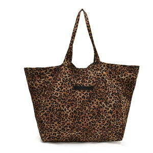 Large leopard print canvas tote bag with dual straps and minimalist black tag design