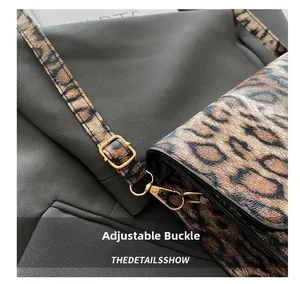 Detail of adjustable gold buckle and premium leopard print texture on crossbody bag