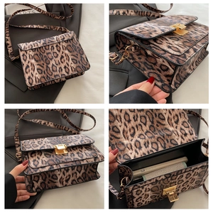 Detail view of leopard print crossbody bag with gold twist lock and interior storage
