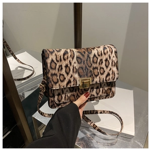 Detail of leopard print crossbody bag with gold square buckle and adjustable strap