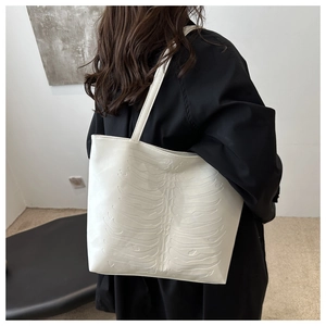 Detailed back view of a white tote bag featuring unique 3D rib-cage embossed texture