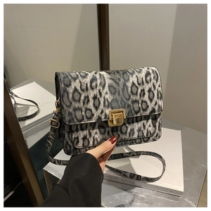 Detailed close-up of leopard print crossbody bag with elegant gold metal square clasp