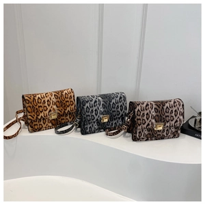 Three leopard print crossbody bags in brown grey and red with gold metal clasps