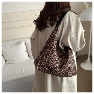 Leopard print tote bag showing large capacity and vintage shoulder strap design