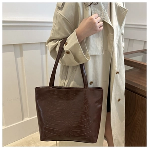 Brown retro tote bag featuring unique rib-cage embossed texture on glossy finish