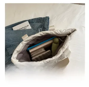 Top view of white quilted tote bag interior showing ample space for daily essentials
