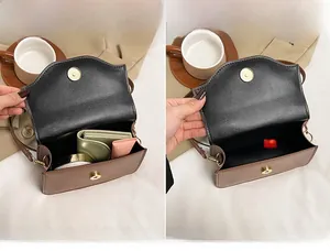 Interior detail of a brown vintage square bag showing the main pocket with magnetic buckle