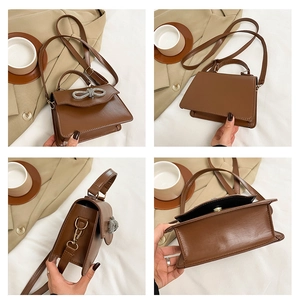 Close-up of brown PU leather crossbody bag featuring a silver rhinestone bow decoration