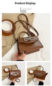 Close-up of coffee brown leather handbag with sparkling rhinestone bow buckle detail