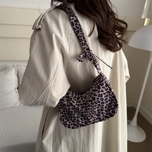 Chic leopard print canvas tote bag with shoulder tie detail shown on a model