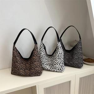 Leopard print canvas hobo bags in classic brown, white, and grey with leather handles
