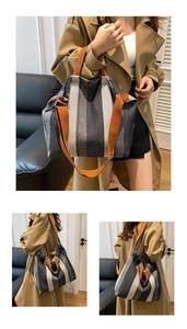 Detailed view of the striped canvas tote bag with adjustable orange textile shoulder straps