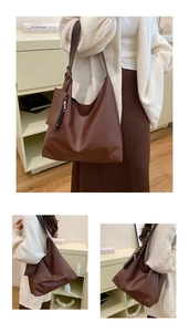 Detail of dark brown faux leather hobo bag with matching detachable pouch for storage