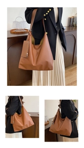 Detail of tan leather tote bag with matching zipper pouch for daily commuting