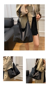 Detail view of large matte black tote bag with a hanging zipper pouch accessory