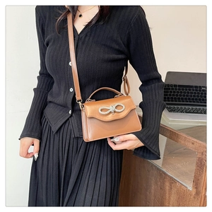 Chic brown leather crossbody bag with sparkling rhinestone bow detail for women