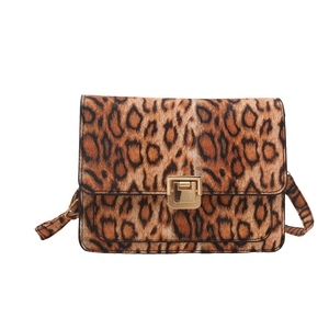 Brown leopard print crossbody bag with gold buckle and adjustable strap on white background