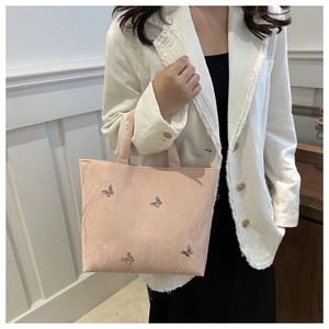 Pink tote bag detail with elegant wave texture and four silver butterfly metal ornaments