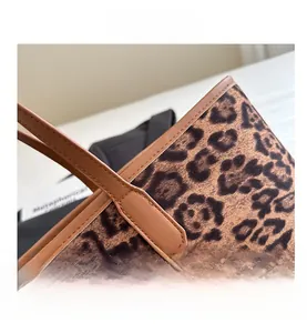 Detail of leopard print tote bag showing premium stitching and brown leather strap