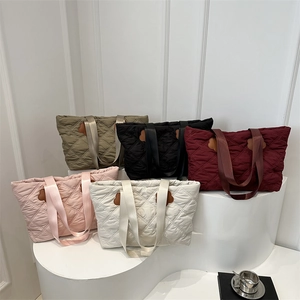 Quilted nylon tote bag set in five colors with diamond stitching and flower charms