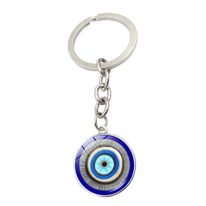 Macro shot of silver metal key ring with glass Turkish Blue Evil Eye amulet charm