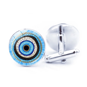 Detail of silver Turkish evil eye cufflinks with blue glass cabochon for men shirts