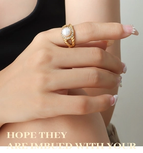 Close-up of vintage gold titanium ring featuring a freshwater pearl and zircon halo
